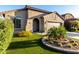 Charming home with an arched entry, desert landscaping, and artificial turf at 11829 W Patrick Ln, Sun City, AZ 85373
