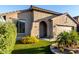Attractive home featuring low-maintenance desert landscaping and artificial turf for curb appeal at 11829 W Patrick Ln, Sun City, AZ 85373