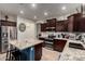 Beautiful kitchen featuring an island, stainless appliances and dark wood cabinetry at 11829 W Patrick Ln, Sun City, AZ 85373