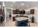 Bright kitchen featuring stainless steel appliances, granite countertops, and a blue kitchen island with seating at 11829 W Patrick Ln, Sun City, AZ 85373
