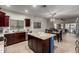 Spacious kitchen with an island and an open-concept layout leading to a dining area at 11829 W Patrick Ln, Sun City, AZ 85373