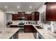 Modern kitchen with stainless steel appliances, granite countertops, and ample cabinet space at 11829 W Patrick Ln, Sun City, AZ 85373