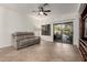 Inviting living room with a comfortable couch and sliding glass doors to the backyard patio at 11829 W Patrick Ln, Sun City, AZ 85373