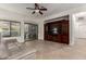 Light-filled living room with a sliding glass door and a wall-mounted entertainment center at 11829 W Patrick Ln, Sun City, AZ 85373