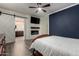 Comfortable main bedroom featuring an en-suite bathroom with sliding barn door and fireplace at 11829 W Patrick Ln, Sun City, AZ 85373