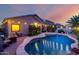 Backyard pool area with string lights creating a relaxed outdoor living space at 11829 W Patrick Ln, Sun City, AZ 85373