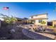 Spacious backyard features a rock garden, a fire pit, and seating for outdoor entertaining at 12233 W Caraveo Pl, Peoria, AZ 85383