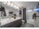 Bright bathroom features double sinks, decorative tile flooring, and bathtub at 12233 W Caraveo Pl, Peoria, AZ 85383