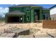 New home in construction stage with visible framing, sheathing, and building materials at 12233 W Caraveo Pl, Peoria, AZ 85383