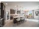 Open kitchen and dining area features stainless appliances, and an island with seating at 12233 W Caraveo Pl, Peoria, AZ 85383