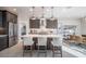 Open kitchen featuring an island with seating, stainless steel appliances, and pendant lighting at 12233 W Caraveo Pl, Peoria, AZ 85383