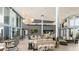 Bright community lounge featuring stylish seating, floor-to-ceiling windows, and decorative lighting at 12233 W Caraveo Pl, Peoria, AZ 85383