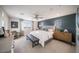 Spacious main bedroom featuring a ceiling fan, an ensuite bathroom, and decorative furnishings at 12233 W Caraveo Pl, Peoria, AZ 85383