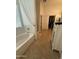 Bright bathroom with a soaking tub and separate shower near a walk-in closet at 14991 W Shaw Butte Dr, Surprise, AZ 85379