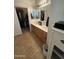Bathroom featuring a double vanity and an adjacent walk-in closet at 14991 W Shaw Butte Dr, Surprise, AZ 85379