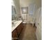 Neutral bathroom featuring a single sink, tiled floor, and decorative chair at 14991 W Shaw Butte Dr, Surprise, AZ 85379