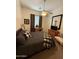 Comfortable bedroom with a ceiling fan, decorative wall art, and neutral decor at 14991 W Shaw Butte Dr, Surprise, AZ 85379