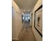 Inviting hallway with neutral tones, decorative art and a stylish rug leading to the living area at 14991 W Shaw Butte Dr, Surprise, AZ 85379