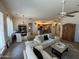 Open-concept living area with a ceiling fan, dining area, and a glimpse of the kitchen at 14991 W Shaw Butte Dr, Surprise, AZ 85379