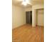 Bedroom with wood floors, closet, and sliding door access at 1622 E Campbell Ave # L, Phoenix, AZ 85016