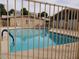 Community pool with fence, blue water, and surrounding buildings at 1622 E Campbell Ave # L, Phoenix, AZ 85016