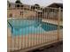 Community pool with fence, blue water, and surrounding buildings at 1622 E Campbell Ave # L, Phoenix, AZ 85016