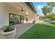 Spacious backyard with a covered patio, lush artificial grass, and a pool at 16428 N 59Th St, Scottsdale, AZ 85254