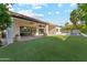 Expansive backyard featuring artificial grass, a covered patio, and inviting pool at 16428 N 59Th St, Scottsdale, AZ 85254