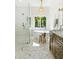 Well-lit bathroom featuring a walk-in shower, soaking tub, dual sinks, marble countertops, and white shiplap at 16428 N 59Th St, Scottsdale, AZ 85254