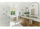 Luxurious bathroom offers dual sinks, marble countertops, a soaking tub, walk-in shower and white shiplap at 16428 N 59Th St, Scottsdale, AZ 85254