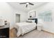 Well-lit bedroom with a sleek ceiling fan, closet, and comfortable bed at 16428 N 59Th St, Scottsdale, AZ 85254