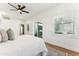 Bright bedroom with white walls, wood floors, and a sliding glass door to the outdoor area at 16428 N 59Th St, Scottsdale, AZ 85254