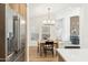 Bright dining room featuring wood floors, modern lighting, and stainless steel appliances nearby at 16428 N 59Th St, Scottsdale, AZ 85254