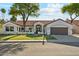 Charming single-story home showcasing a lush front yard and inviting curb appeal at 16428 N 59Th St, Scottsdale, AZ 85254