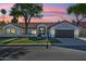 Charming single-story home showcasing a lush front yard and a beautiful sunset sky at 16428 N 59Th St, Scottsdale, AZ 85254