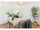 Bright home office featuring a stylish desk, chandelier, and French doors at 16428 N 59Th St, Scottsdale, AZ 85254