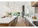 Long kitchen island featuring stainless steel appliances, sleek countertops, and modern pendant lighting at 16428 N 59Th St, Scottsdale, AZ 85254