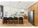 Bright kitchen featuring a large island with bar seating, custom cabinets, and stainless steel appliances at 16428 N 59Th St, Scottsdale, AZ 85254