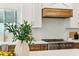 Bright kitchen boasts stainless steel appliances, white marble counters and backsplash, and wood accents at 16428 N 59Th St, Scottsdale, AZ 85254