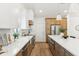 Bright modern kitchen with stainless steel appliances, a large island with bar seating and stone countertops at 16428 N 59Th St, Scottsdale, AZ 85254