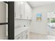 Clean, bright laundry room with modern white cabinets and stylish tiled floors at 16428 N 59Th St, Scottsdale, AZ 85254