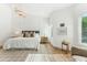 Light-filled main bedroom features hardwood floors, panelled walls, neutral furnishings, and recessed lighting at 16428 N 59Th St, Scottsdale, AZ 85254