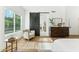 Stylish main bedroom with hardwood floors, a comfortable armchair, and a modern barn door leading to the bathroom at 16428 N 59Th St, Scottsdale, AZ 85254