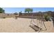 Spacious gravel backyard with a charming swing set, desert plants, and a brick perimeter for outdoor enjoyment at 17229 N 51St Dr, Glendale, AZ 85308