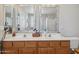 Bathroom featuring a double sink vanity with wood cabinets at 17229 N 51St Dr, Glendale, AZ 85308