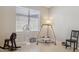 Bright bedroom featuring a large window, playful rocking horse, and minimalist decor providing a calming atmosphere at 17229 N 51St Dr, Glendale, AZ 85308