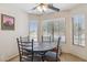 Cozy dining area with a round table, four chairs, bright natural light, and neutral decor for a welcoming space at 17229 N 51St Dr, Glendale, AZ 85308