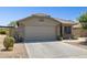Charming single-story house with a tile roof, desert landscaping, and a two-car garage for convenient parking at 17229 N 51St Dr, Glendale, AZ 85308
