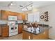 Well-lit kitchen featuring track lighting and a window over the sink at 17229 N 51St Dr, Glendale, AZ 85308