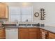 The kitchen area features a double stainless steel sink and oak cabinets at 17229 N 51St Dr, Glendale, AZ 85308